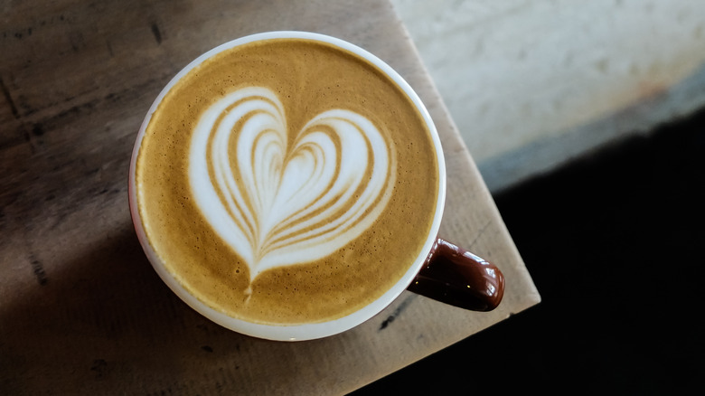 Latte with heart art design in a cup 