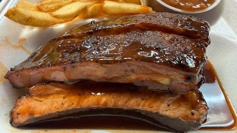 Cozy Corner ribs dressed in sauce in a styrofoam container