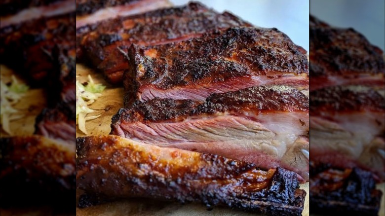 a rack of ribs from heirloom market sliced on a board