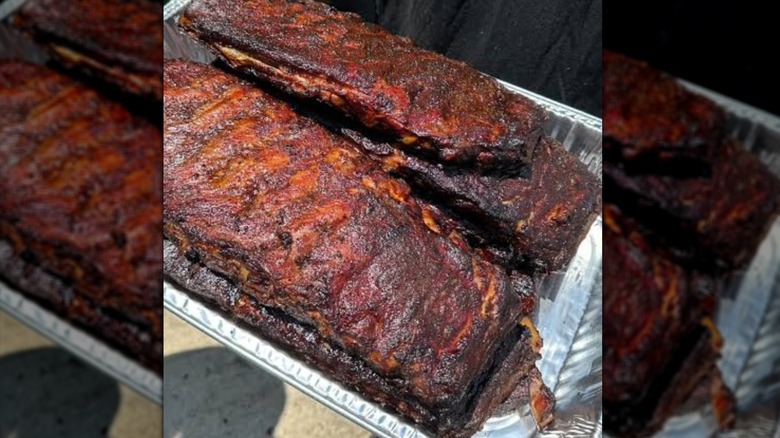 A metal tray of Heritage BBQ's smoked ribs