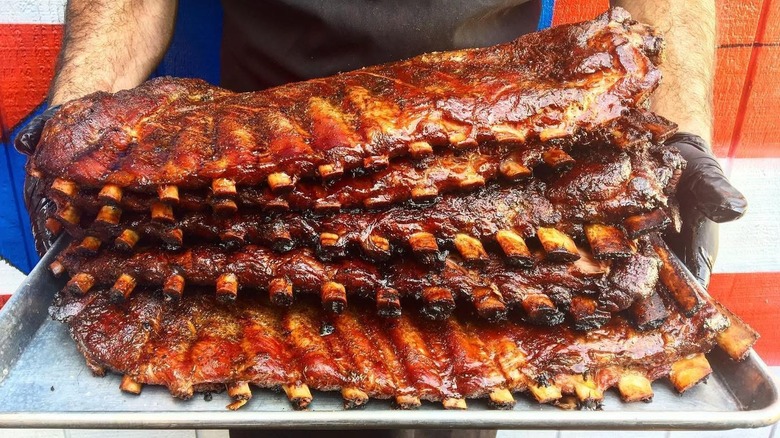 A tray with five racks of ribs stacked on top of each other