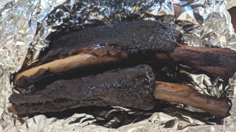 Large ribs sit on aluminum foil at Little Miss BBQ in Phoenix, Arizona