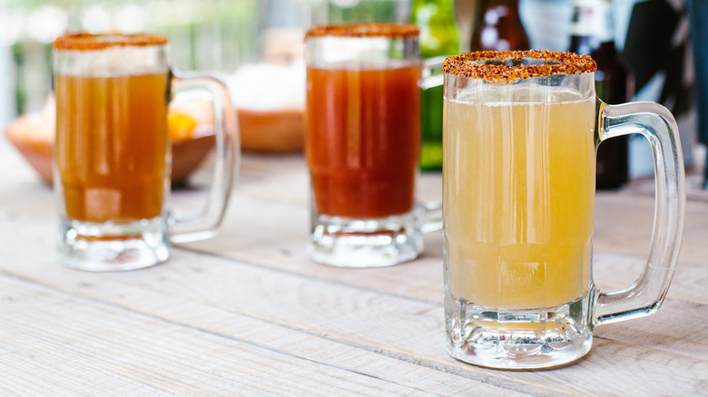 Pints of beer and micheladas with spicy salt rims