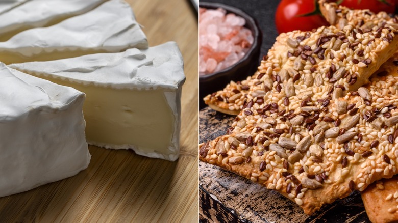 slice of camembert on board and seeded crackers in pile