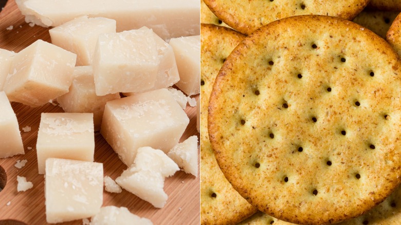 cubes of Parmesan cheese on board and pile of whole wheat crackers