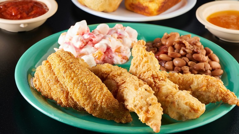 Plate of fried chicken, catfish, and sides served at Bubba's Cooks Country.