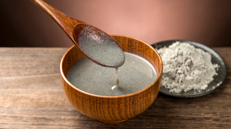 A spoonful and bowl of black sesame paste.