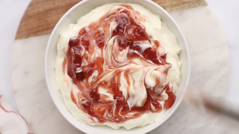 A bowl full of strawberry cheesecake dip.
