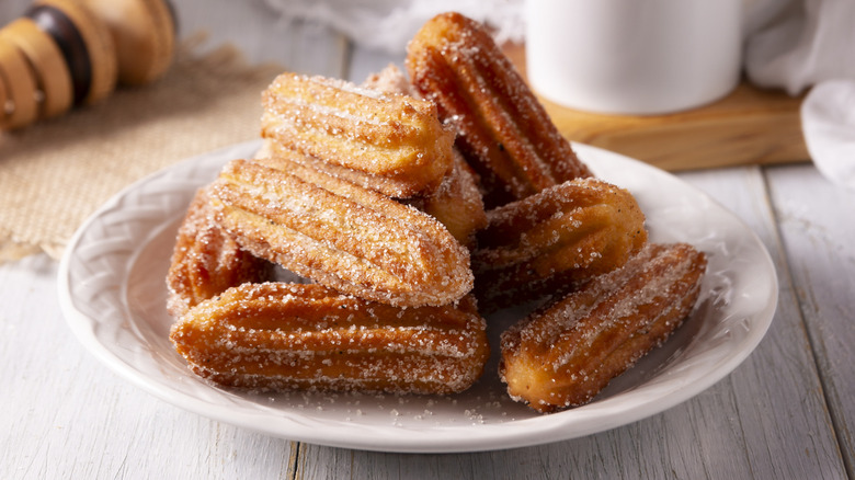 Fried churros on a plate.
