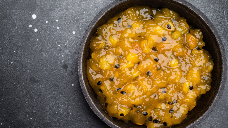 Mango and passionfruit coulis in a cast iron pan.