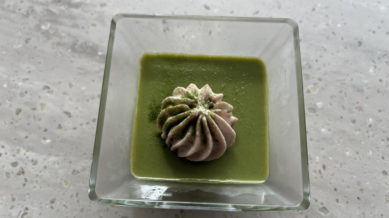 A square glass of matcha white chocolate sauce.
