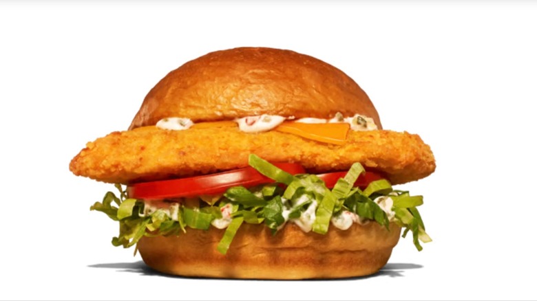 Closeup of Arby's King's Hawaiian Fish sandwich on a white background