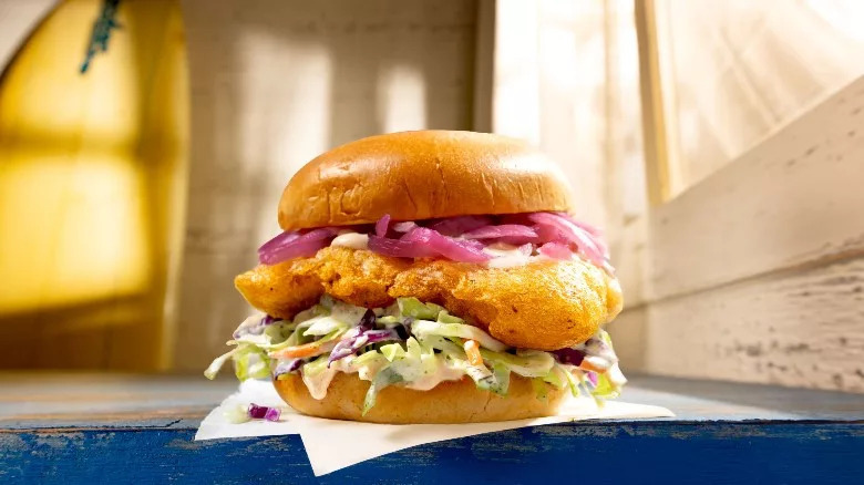 Habit's beer-battered cod served with coleslaw and pickled red onions on a bun