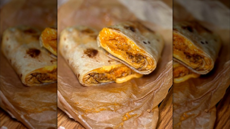 A Taco Bell Quesarito has been cut in half.