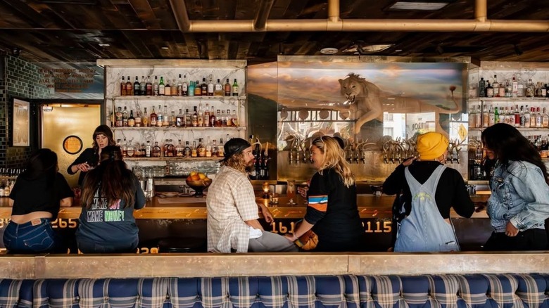 Patrons sitting at the bar of Craft & Commerce in San Diego