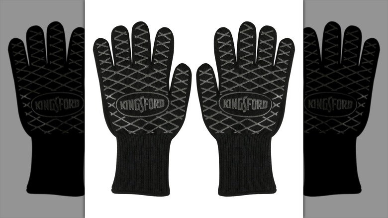 Heavy duty grilling gloves sit against a white background