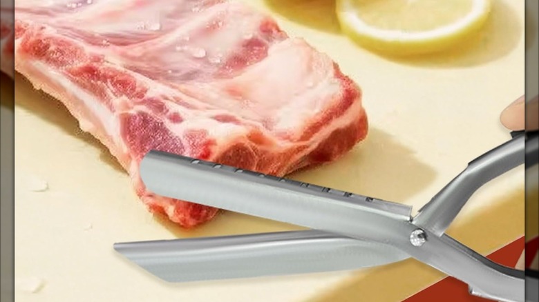 A pair of membrane snippers waits near a rack of ribs.