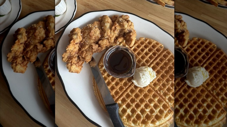 Chicken and waffles on a white plate.