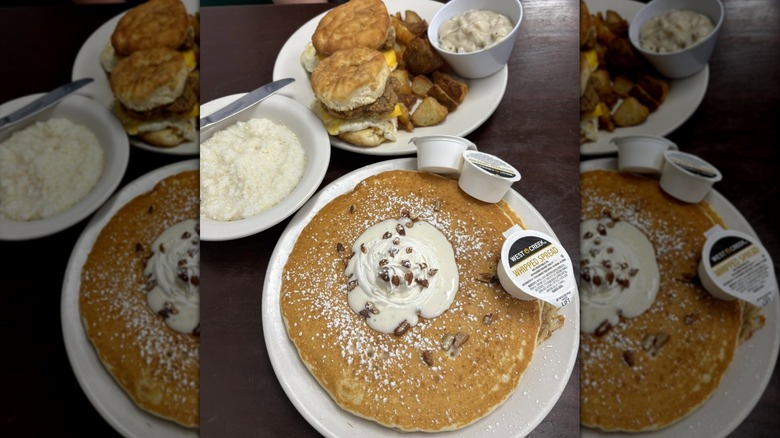 Pancakes, biscuit sandwiches, and potatoes on white plates.