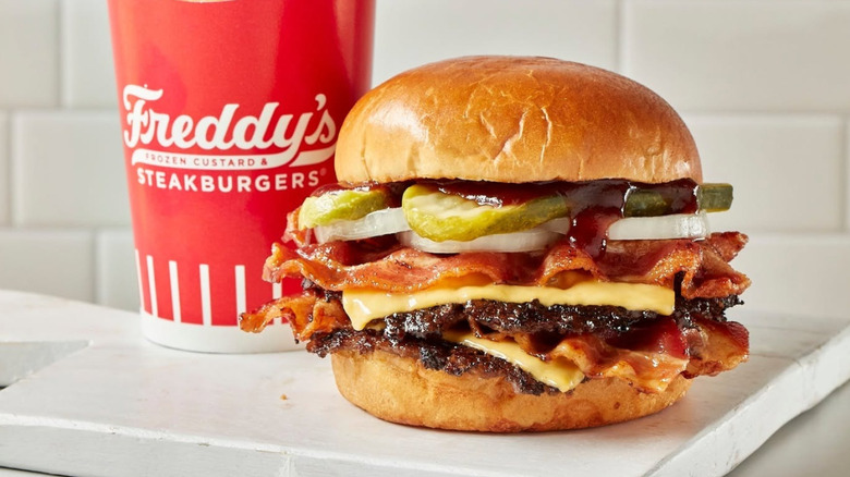A burger is loaded with toppings.