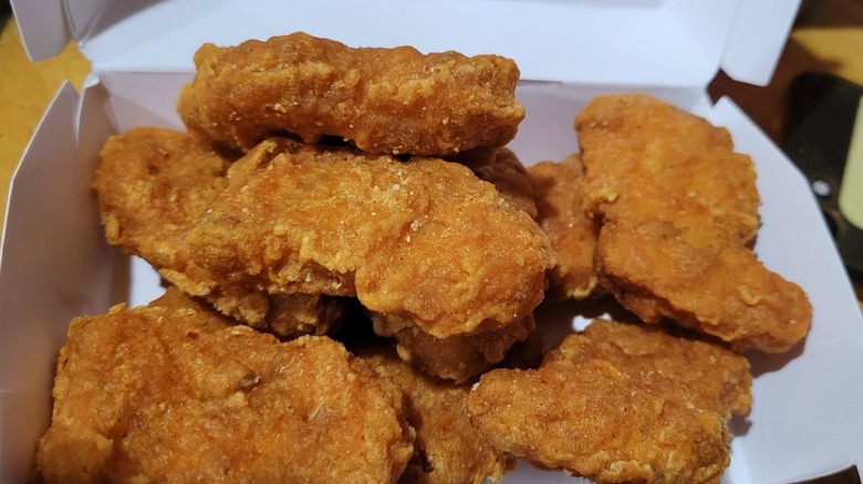 Spicy Chicken McNuggets sit in their box.