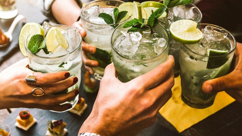 friends toasting with mojitos