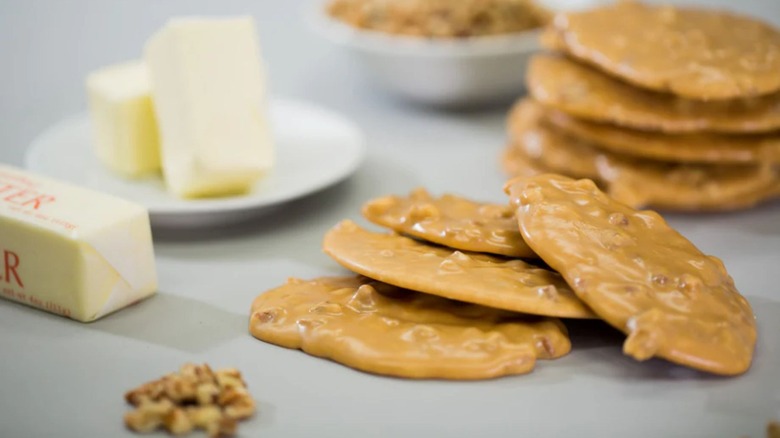 Stacks of pralines beside sticks of butter