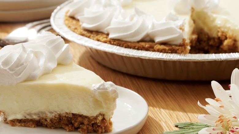 Slice of Key lime pie plated before the whole dish