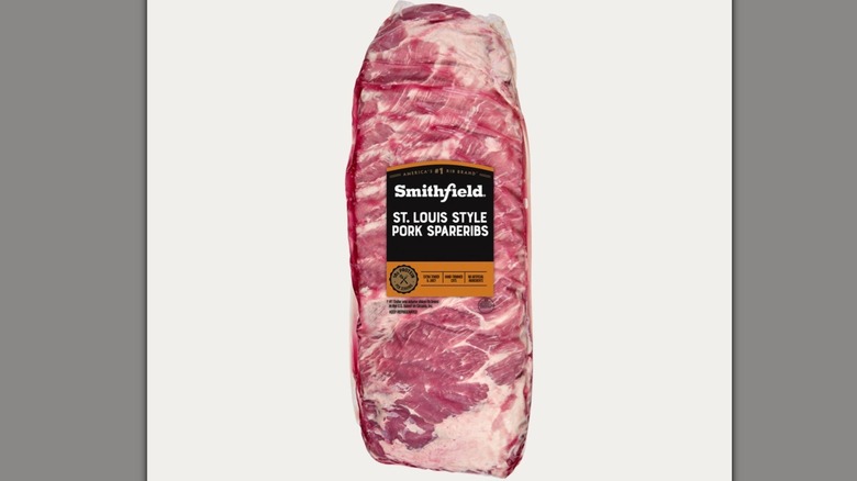 A rack of Smithfield Fresh Pork St. Louis Style Spareribs is cooking on the grill