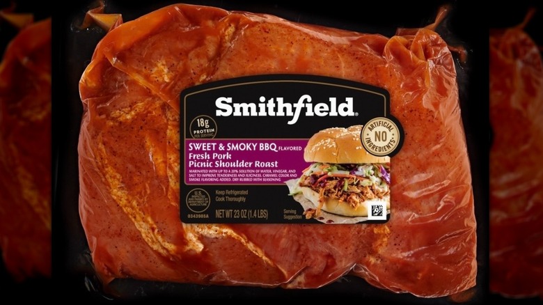 A cooked Smithfield Sweet & Smoky BBQ Fresh Pork Picnic Shoulder Roast sits on a wooden cutting board