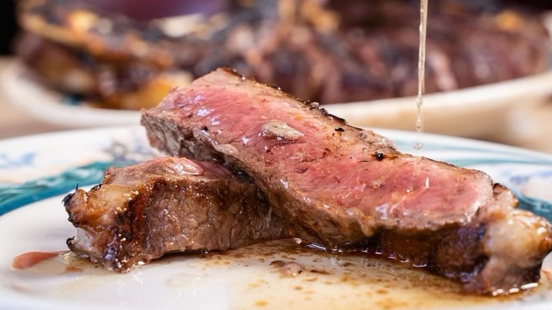 sliced steak sauce pour