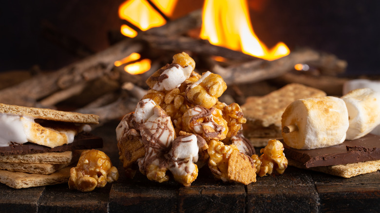 S'mores popcorn in front of a campfire