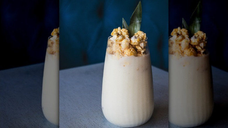 A piña colada with a popcorn garnish