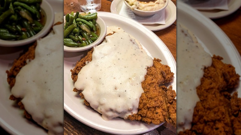 Country Fried Chicken smothered in cream gravy, served with green beans and mashed potatoes