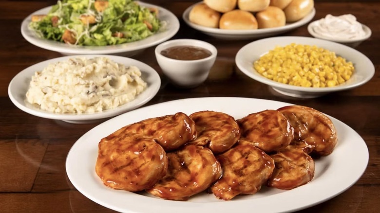 Family-sized order of Grilled BBQ Chicken with sides, salad, and rolls