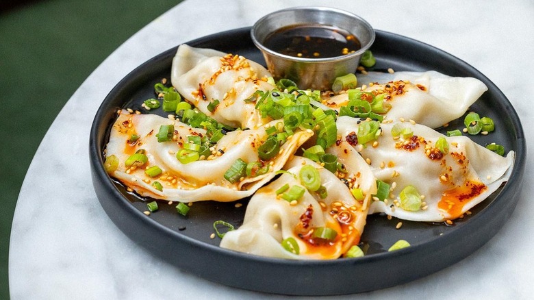Plate of vegan dumplings with dipping sauce from Beyond Sushi