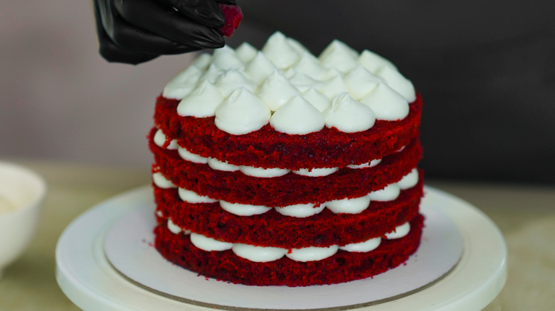 Multi-tiered red velvet cake with cream cheese icing