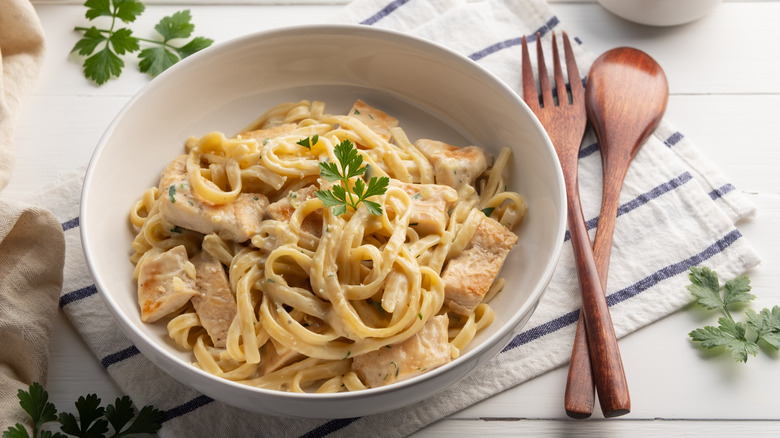 Chicken alfredo in a white bowl