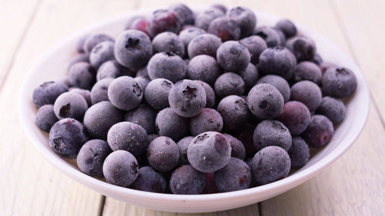 Frozen blueberries in a white plate
