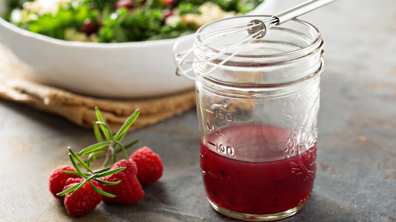 raspberry salad dressing with whisk in jar
