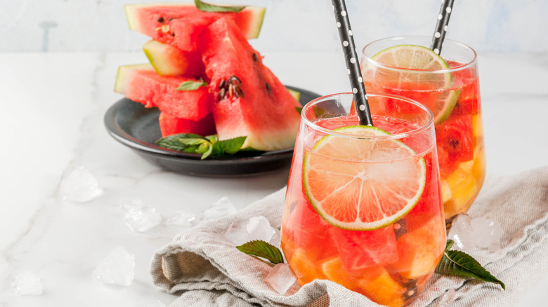 Glasses of watermelon lemonade with lime slices