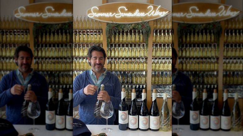 Billy Dim opening a bottle of Summer Somewhere wine