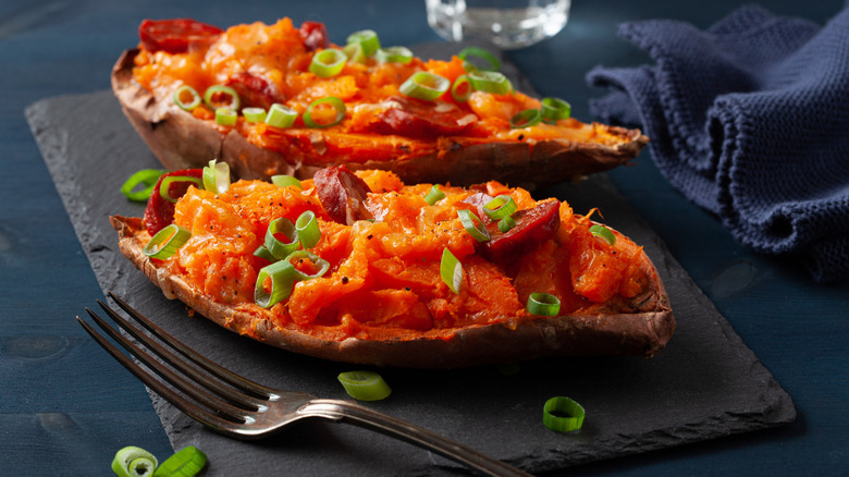 Two twice-baked sweet potatoes on a stone serving slab