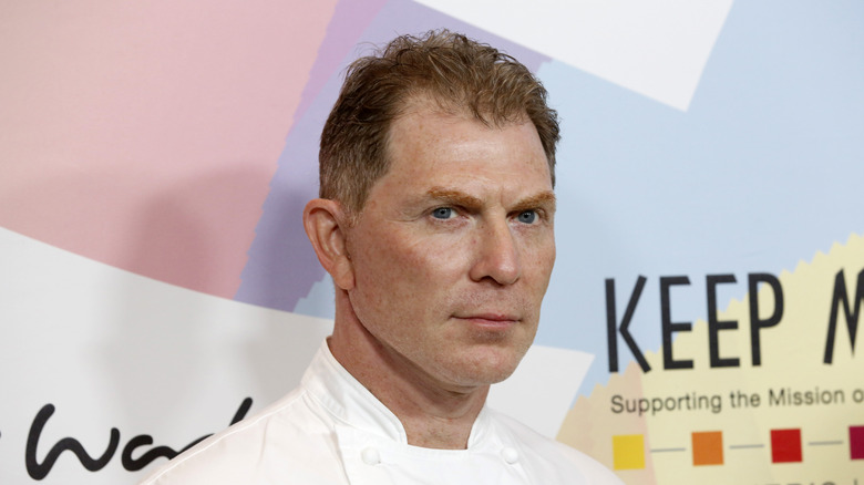 Bobby Flay posing at an event.