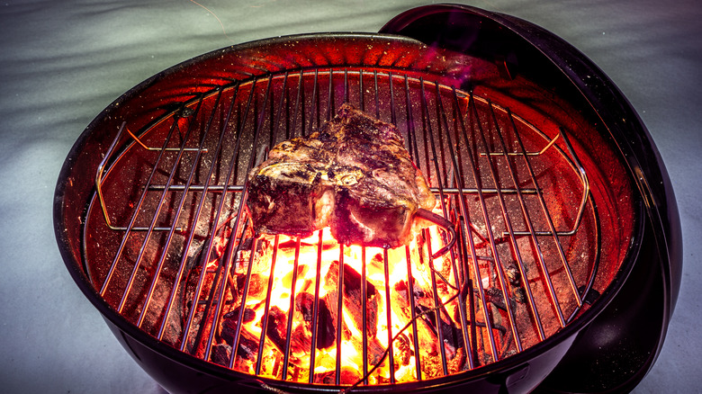 steak cooking on Weber grill