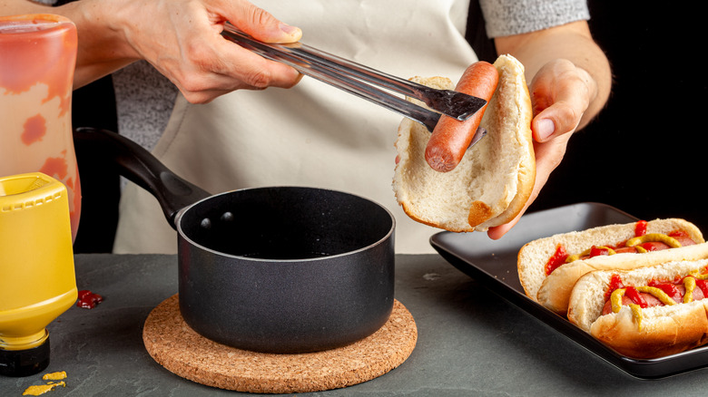 preparing boiled hot dogs