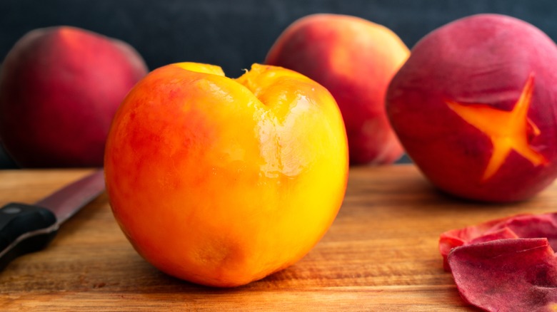 Peeled peach on a cutting board