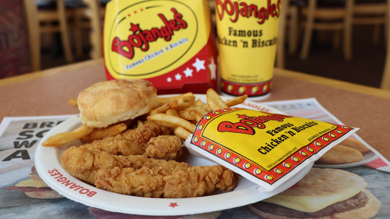 A plate of Bojangles' chicken, fries, and a biscuit.