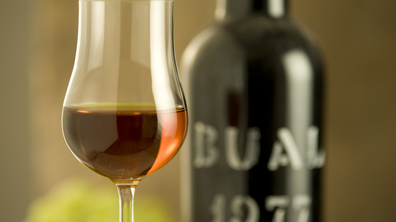 glass of port with bottle in background