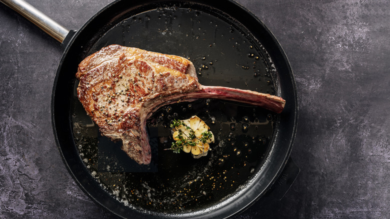 Cooked bone-in steak in a pan